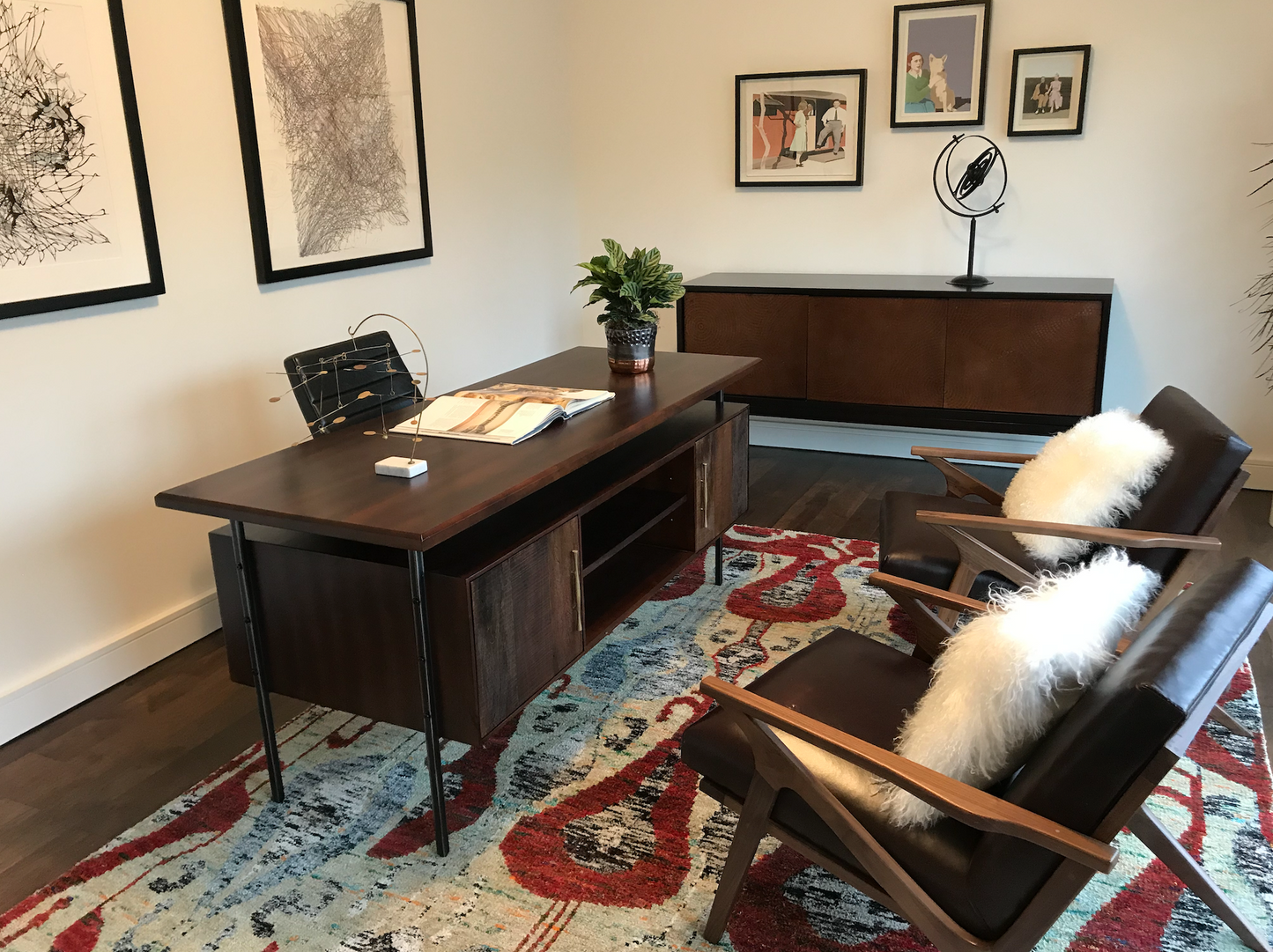 Dark wood desk with brass hardware, floated top, iron legs