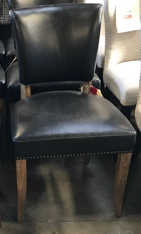 Black leather dining chair with brown legs and nail head trim