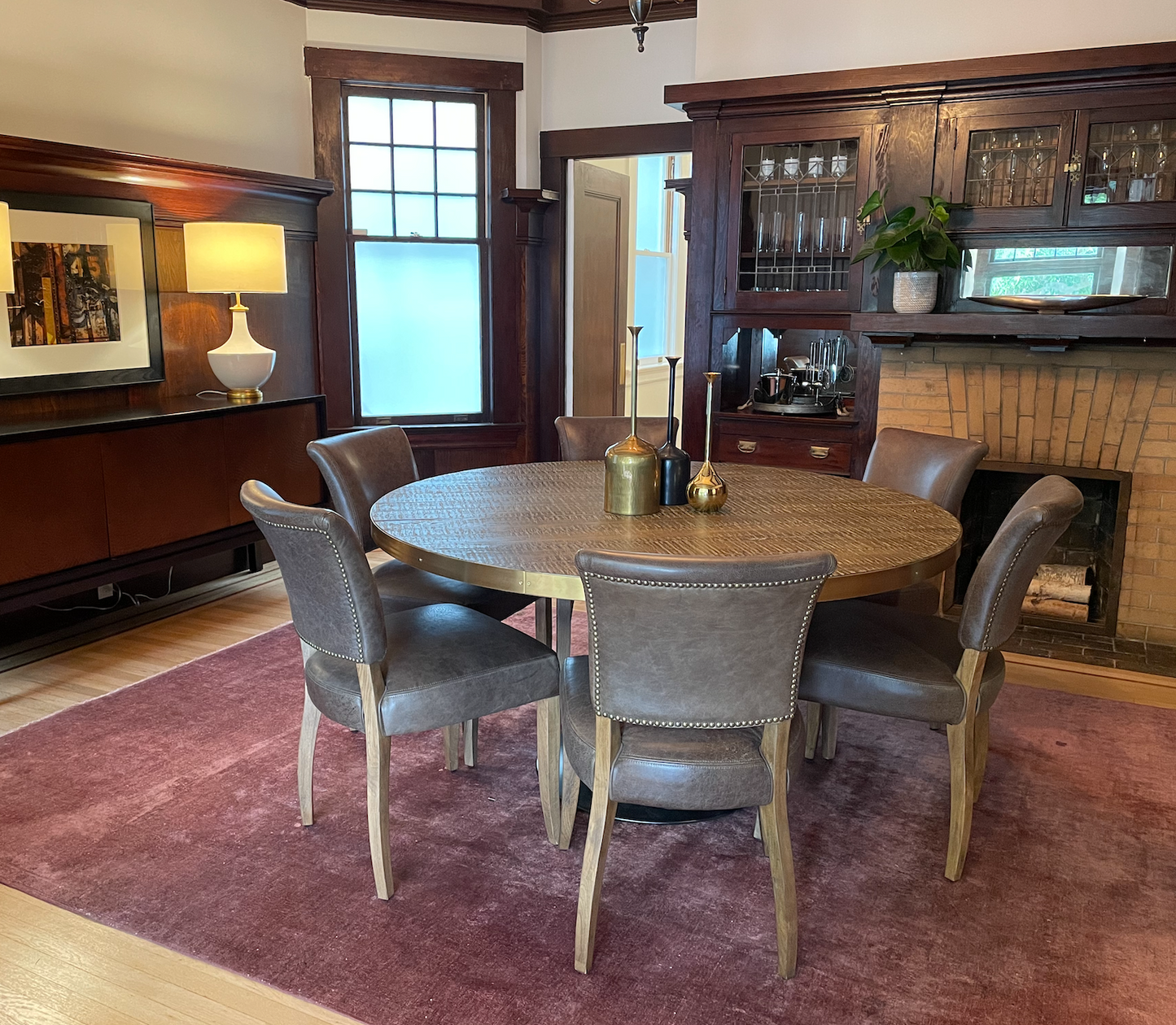 Brown leather dining chair with brown legs and nail head trim