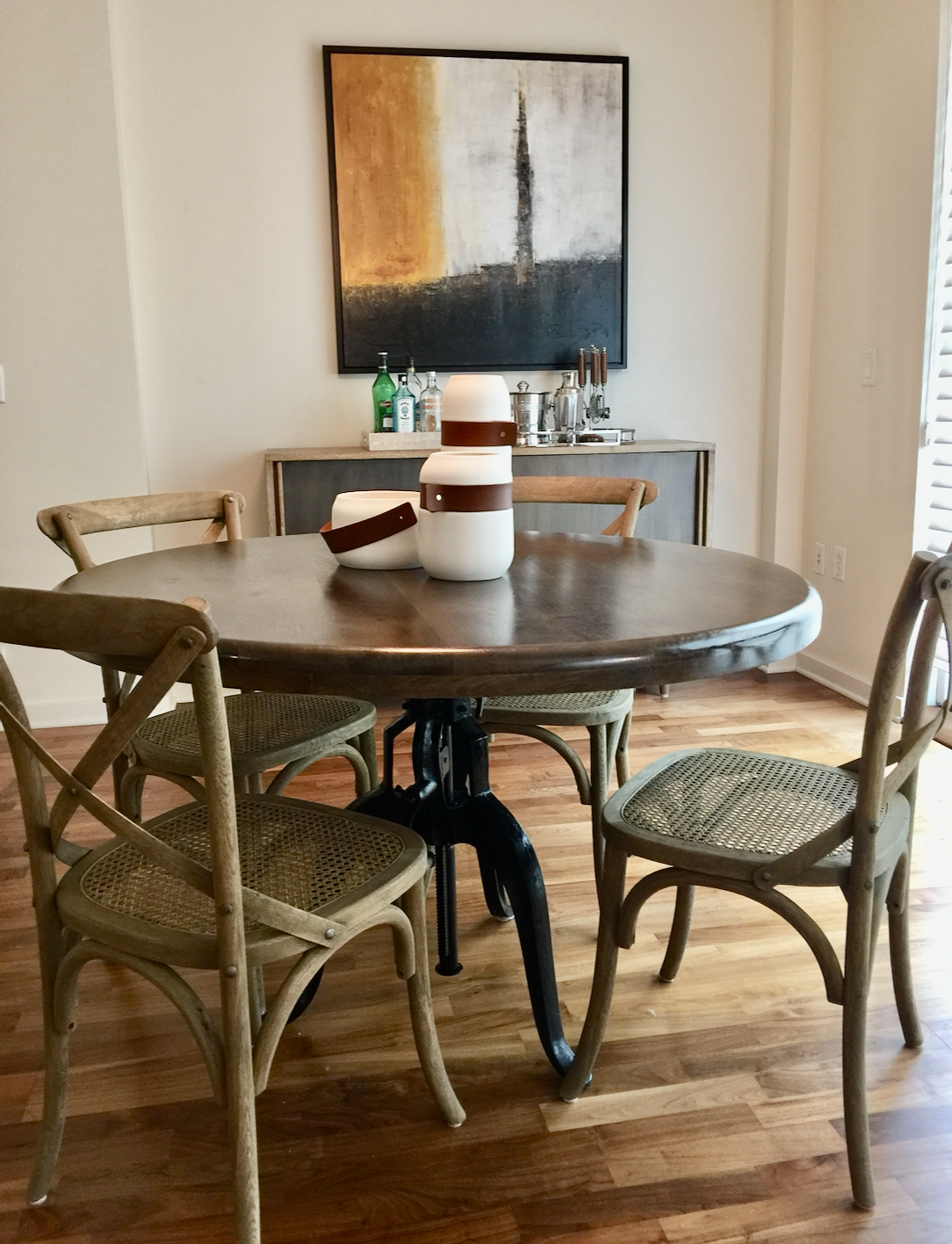 Round polished wood top dining table with cast iron crank industrial base