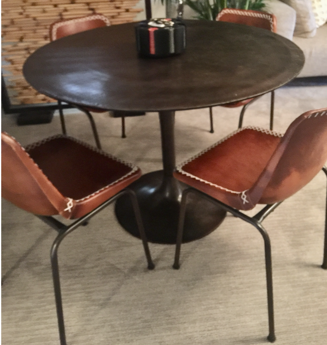 Round antique rust dining table with tulip pedestal base