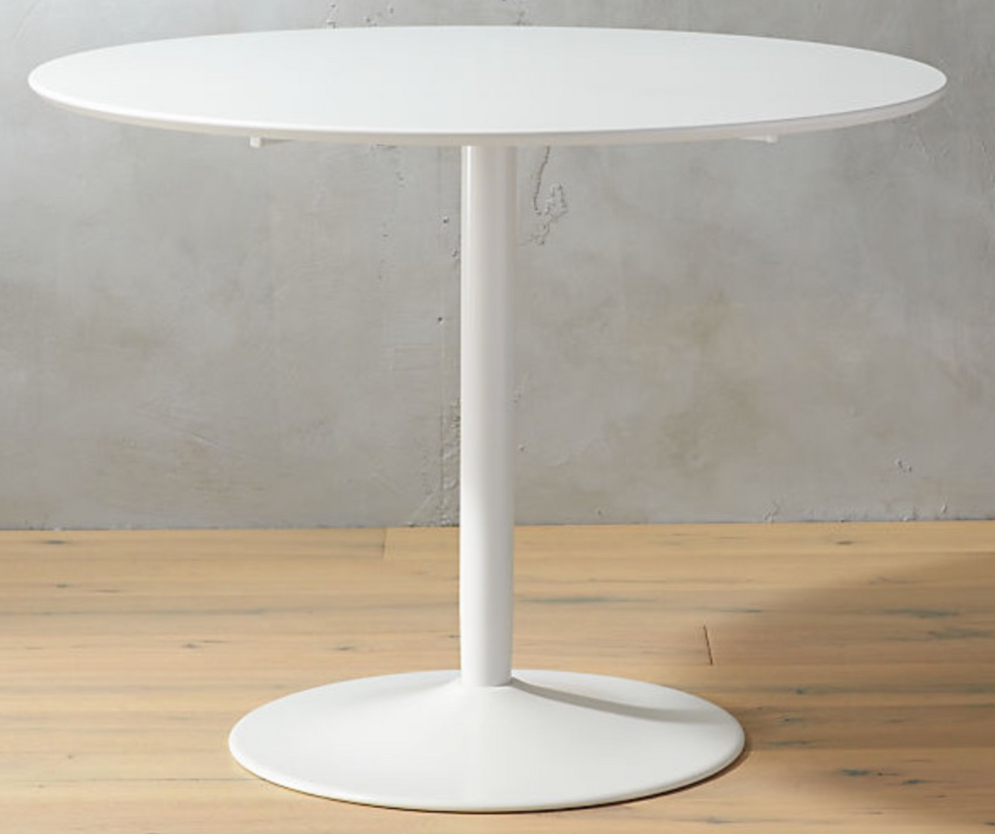 Round white dining table with pedestal base