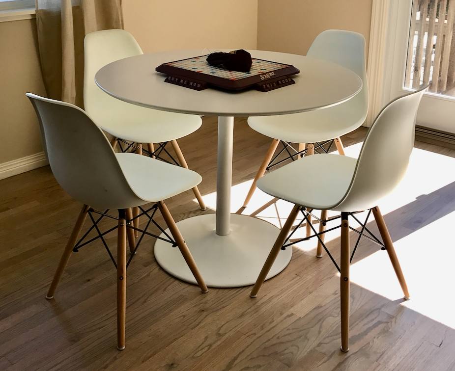 Round white dining table with pedestal base