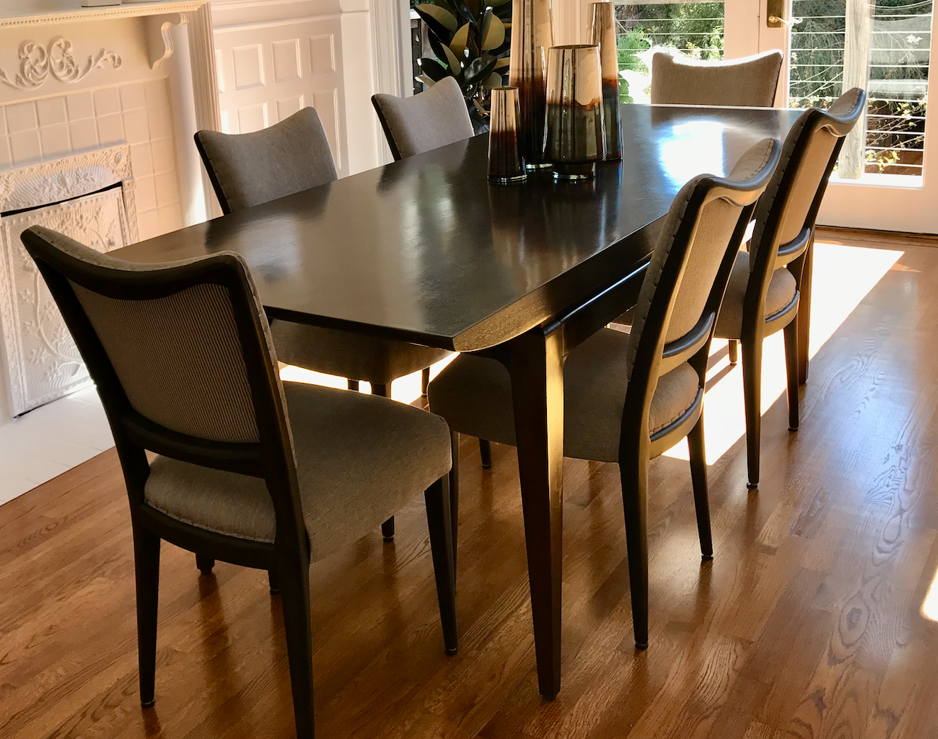 Dark polished wood canoe dining table